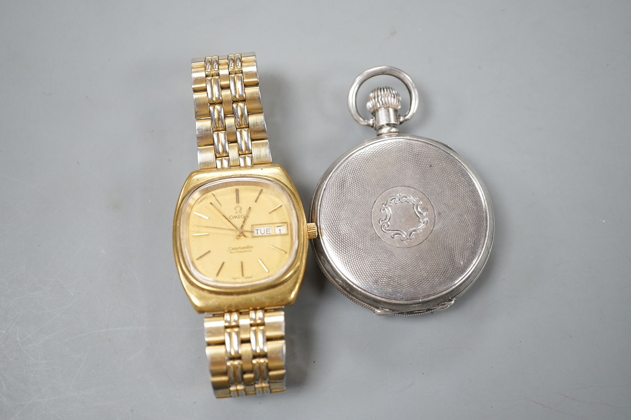 A George V silver Omega open face keyless pocket watch and a gold plated Omega Seamaster day/date automatic wrist watch.